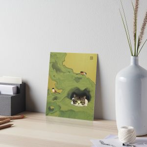 Art board with picture of cat peeping out of a hole in rock. Two birds are perched on the rock.