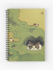 Notebook with cover art of cat peeping out of a hole in rock. Two birds are perched on the rock.